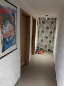 a hallway with a painting of a clock on the wall at Ferienwohnung Schmahl in Schleiden