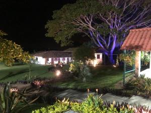 a house with lights in the yard at night at Finca Hotel Brasilia in La Tebaida