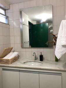 a bathroom counter with a sink and a mirror at 2 min do mar Ponta Verde in Maceió +24 photos