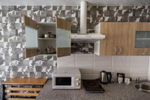 a kitchen with a microwave oven and a counter top at Апартаменты-студия на пр Науки,Мечникова in Dnipro