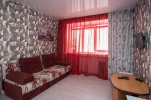 a living room with a couch and a window at Апартаменты-студия на пр Гагарина in Dnipro