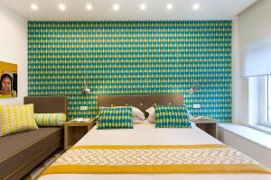 a bedroom with a bed and a colorful wall at Casa Dominova de Luxe in Sorrento
