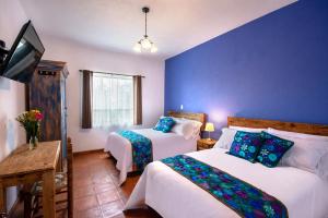 Postel nebo postele na pokoji v ubytování Hotel Camino Antiguo