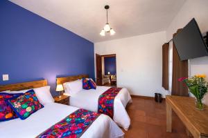 Postel nebo postele na pokoji v ubytování Hotel Camino Antiguo