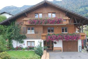 a house with flowers on the front of it at Haus Schneider in Andelsbuch