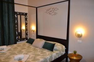 a bedroom with a bed with a large mirror at Rio Groppo Guesthouse in Manarola