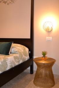 a bedroom with a bed and a table with a lamp at Rio Groppo Guesthouse in Manarola