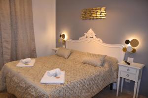 a bedroom with a bed with two towels on it at Rio Groppo Guesthouse in Manarola