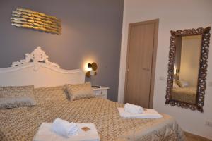 a bedroom with a large bed with two towels on it at Rio Groppo Guesthouse in Manarola