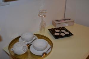 a table with two cups and a tea set at Rio Groppo Guesthouse in Manarola