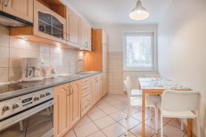 a kitchen with a table and a dining room at CITYSTAY Okrzei Sopot Apartment in Sopot