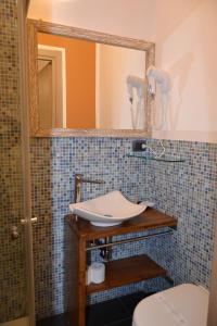 a bathroom with a sink and a mirror at Rio Groppo Guesthouse in Manarola