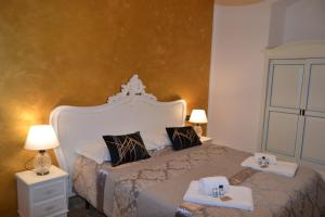 a bedroom with a large bed with two towels on it at Rio Groppo Guesthouse in Manarola