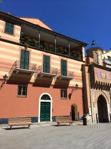 a building with two benches in front of it at Koala in Finale Ligure