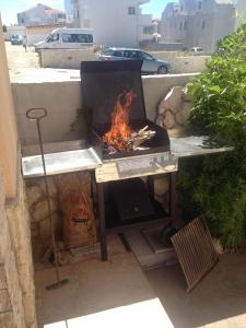 een tafel met een grill met een vuur erin bij Put Lokvice 50 in Novalja