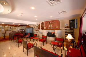a living room with red chairs and a fireplace at Erzurumlu Hotel in Kilyos