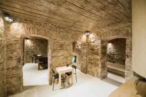 a room with a stone wall and a stone fireplace at Old Central Apartment in Cluj-Napoca
