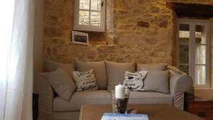 a living room with a couch and a table at Le Rousseau Sarlat in Sarlat-la-Canéda