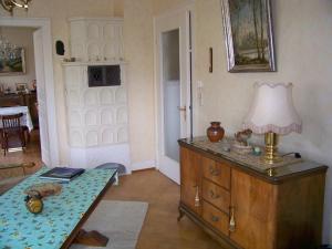 a room with a table and a lamp on a dresser at Villa - Sonnenberg in Obersulm