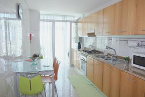 a kitchen with a glass table and a counter top at Marisol Ocean View in Praia da Barra
