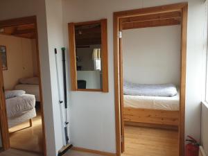 A bed or beds in a room at Við-Bót Riverside Cottage