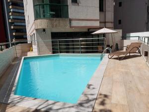 a swimming pool on the side of a building at Costa Victoria Residence in Vitória