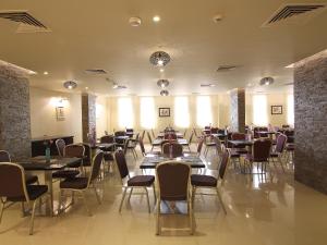 a restaurant with tables and chairs in a room at Florida Al Souq Hotel (Previously Known Flora Al Souq Hotel) in Dubai