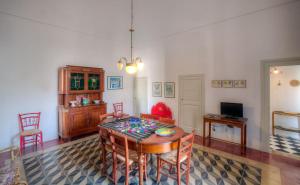 a dining room with a table and chairs and a television at Nostalgia di Castro in Castro di Lecce