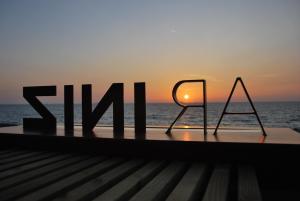 a sign that reads skilimum sitting on top of the ocean at Hôtel Ar Iniz in Saint Malo