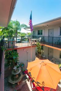 an orange umbrella on a balcony with an american flag at Richard's Motel Studios in Hollywood