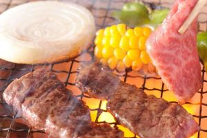 a tray of food with meat and fruit on it at るり渓フォレストコテージ in Nantan city +19 photos