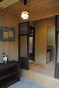 a room with two windows and a pendant light at NARAigoto EENA HOUSE in Nara