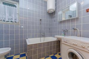 a bathroom with a washing machine and a sink at House Marina in Zaboric