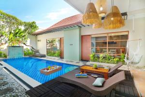 a swimming pool in the backyard of a villa at The Vie Villa in Legian