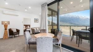 a dining room with a table and chairs and a view at Remarkables Garden 406 - Top Corner Unit - Super Convenient in Queenstown