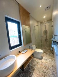 a bathroom with a sink and a toilet and a window at Through A Path in Tainan +33 photos