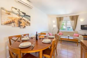 a dining room and living room with a table and chairs at Monte Rosa in Jávea