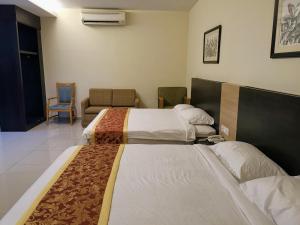 Ein Bett oder Betten in einem Zimmer der Unterkunft Hotel Centre Point Tampin