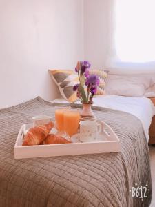 a tray of breakfast food on a bed at Apartamento Calipso in Salou