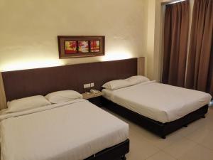 Ein Bett oder Betten in einem Zimmer der Unterkunft Hotel Centre Point Tampin