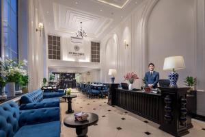 a man standing at a desk in a hotel lobby at My Boutique Hotel & Spa in Sa Pa