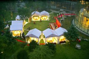 an aerial view of a festival with white tents at The Lakeview Hotel in Beijing