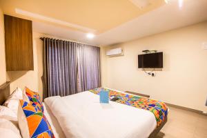 a hotel room with a bed and a tv at FabExpress Silver Lake in Mumbai