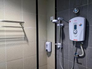 eine Dusche im Bad mit einem Telefon an der Wand in der Unterkunft Hotel Centre Point Tampin in Malakka