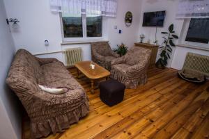 a living room with two chairs and a table at Rozboudovec in Křemže