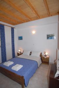 a bedroom with a bed and a wooden ceiling at Villa Frias in Asprogerakata +47 photos