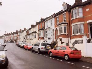 a row of cars parked on the side of a street at 96 Rochester Street in Chatham