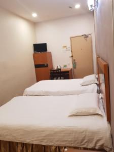 Postel nebo postele na pokoji v ubytování New City Hotel