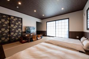 En eller flere senge i et værelse på Kotonone Mai Suzu