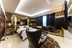 a hotel room with a bed and a desk and chairs at Astro Hotel in Yongin